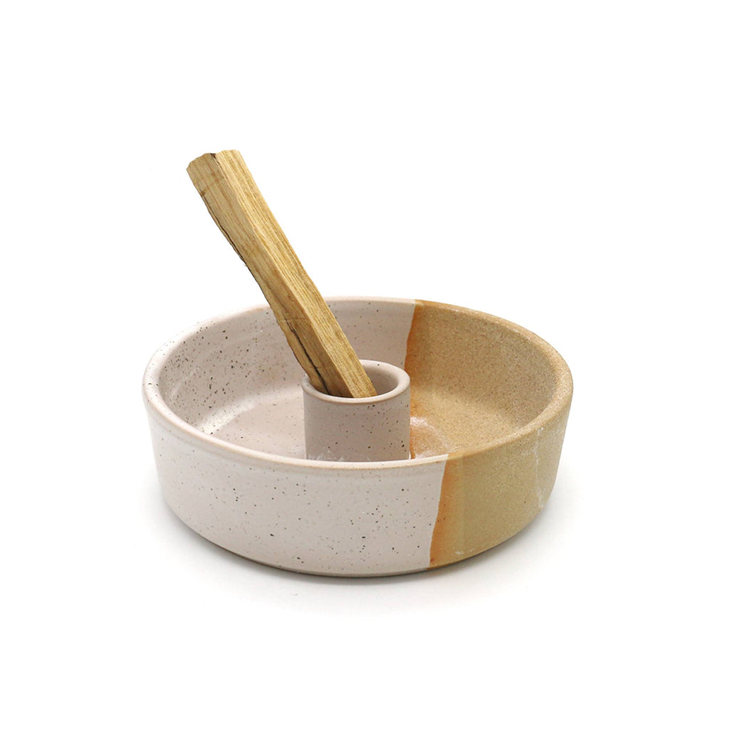 Ceramic bowl with wooden spoon on a white background