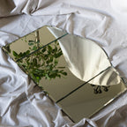 Foldable mirror with geometric design on a white fabric background
