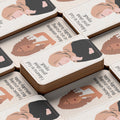 Stack of cards with illustrations of women and text on a beige background