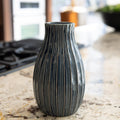 Blue and white striped vase on a marble countertop