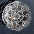 Decorative crystal bowl with geometric patterns on a dark background