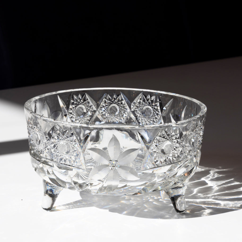 Crystal bowl with intricate cut patterns on a reflective surface