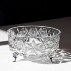 Crystal bowl with intricate cut patterns on a reflective surface