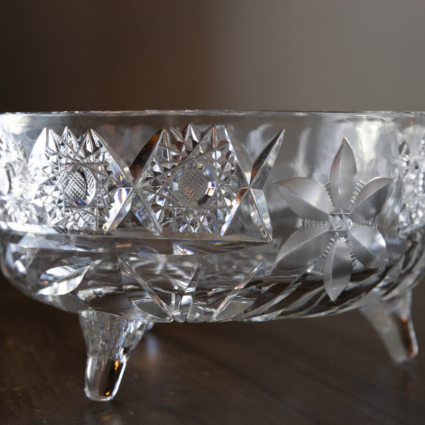 Crystal bowl with intricate cut patterns on a dark surface