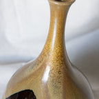 Close-up of a ceramic vase with a textured surface on a white background
