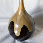 Ceramic vase with gradient finish on a white fabric background